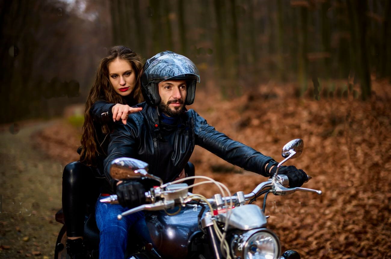 couple-of-motorcyclists-with-a-chopper-in-the-woods-in-the-fall-2H8W0ER.jpg